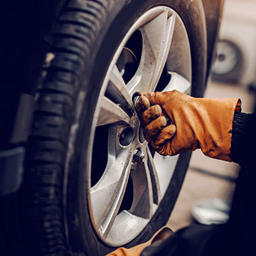 Mechanic Working On Wheel